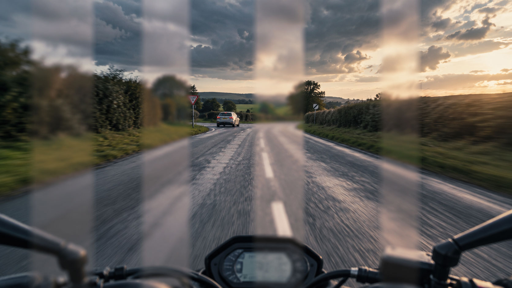 A motorcyclist riding down a road, image simulates saccadic masking
